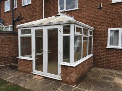 Conservatory with weathered polycarbonate roof before replacement