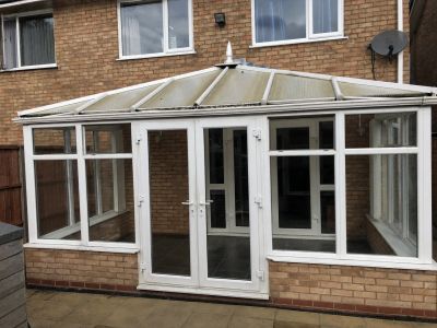 Conservatory with old translucent polycarbonate roof before replacement