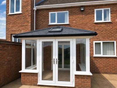 Conservatory with solid tiled warm roof and Velux roof window after replacement